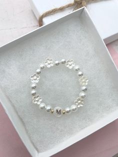 White Pearl Initial Personalized Letter Bracelet - A Perfect Gift for Flower Girls and First Communion Celebrate life's special moments with our White Pearl Initial Personalized Letter Bracelet, a charming and thoughtful gift designed to make your little one feel extra special. Crafted with a delicate combination of glass pearls, a Mother of Pearl initial bead, and beautiful acrylic flower beads, this bracelet is the perfect accessory for flower girls, a first communion, or any meaningful occasi Stretchy Beaded Bracelet, Letter Bracelet, Personalized Letters, Acrylic Flowers, First Communion, Daisy Flower, White Pearl, High Quality Jewelry, Beaded Flowers