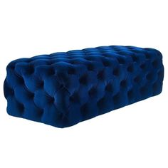 a blue velvet bench with buttons on the top and bottom, in front of a white background