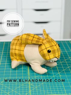 a close up of a stuffed animal on a cutting board with the words pur sewing pattern above it