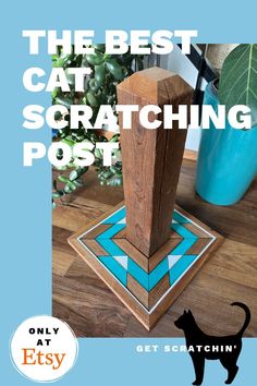 a wooden post sitting on top of a wooden floor next to a potted plant