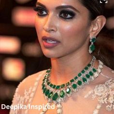 an image of a woman wearing green jewelry