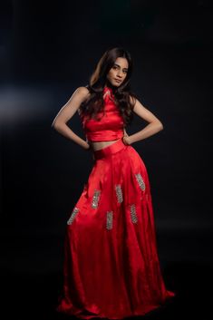 Adding a touch of royal elegance and grace to weddings and festivities, this stunning scarlet-red lehenga is a must-have! The cupro satin fabric is soft and lightweight, making it perfect for twirling around the dance floor. The intricate hand-embroidered mirror work adds a unique sparkle to your look.Details Neckline: Halter neck Material: Cupro satin Lining: Cotton-polyester Made in India Material This outfit is made with cupro satin; the fabric is made from cotton linter wasteIt is a sustainable alternative to polyester Silk Lehenga With Intricate Embroidery For Party, Party Silk Lehenga With Intricate Embroidery, Evening Silk Lehenga With Zari Work, Silk Sharara For Evening And Diwali, Silk Sharara For Diwali Evening, Festive Raw Silk Evening Set, Elegant Art Silk Sharara For Evening, Party Wear Floor-length Raw Silk Palazzo Set, Silk Party Wear Lehenga For Evening