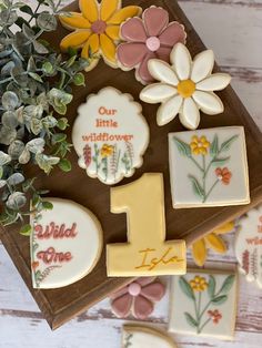 decorated cookies with flowers and the number one on them