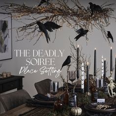 a dining room table with candles and black birds on the branches above it that says, the deadly soiree place setting