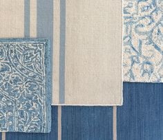 blue and white rugs are arranged on top of each other, with different patterns