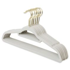 white plastic hangers with gold colored clips