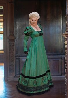 This Regency dress is pure romance! You will love wearing it to be introduced at court or attend a ball. It is the perfect dress for any early-19th century formal winter gathering.  A flattering square neckline tops things off, met on each side by puffed sleeves, extending to the wrists in a classic Regency winter look. The back of the bodice is truly designed to be seen on the ballroom floor - four rows of Venice lace will ensure that everyone will notice you as you dance by.  The same lace lin Formal Historical Floor-length Dress, Elegant Evening Gown With Overbust, Elegant Evening Gown With Overbust Shape, Elegant Fitted Costume Dress, Historical Design Ball Gown For Evening, Elegant Overbust Formal Gown, Victorian Floor-length Fitted Dress, Fitted Floor-length Victorian Dress, Green Formal Dress With Historical Design