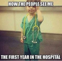 a little boy in green scrubs with a stethoscope on his head