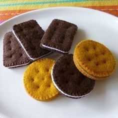 there are four cookies on the plate and one is made out of crochet