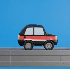 a toy car is sitting on top of a wall