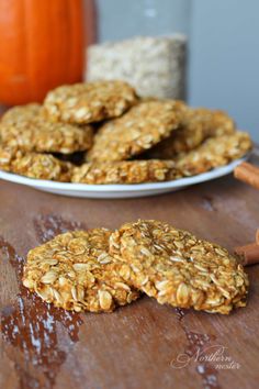 some cookies are on a table next to a pumpkin