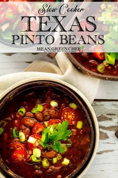 two bowls filled with chili and beans on top of a wooden table