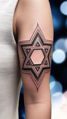 a woman's arm with a tattoo on it and an image of the star of david