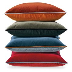 four pillows stacked on top of each other in different colors and sizes, with the same color