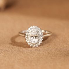 a diamond ring sitting on top of a table