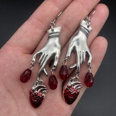 Drench your ears with these sultry Bleeding Heart Earrings with Red Blood Drops! Make a statement with these romantic gothic earrings, and let everyone know you have a heart of darkness. 'Tis a (blood) thirsty accessory to add to your wardrobe! Metals Type: Zinc alloy Vampire Ghost, Just Aesthetic, Witchcraft Jewelry, Dripping Blood, Vampire Earrings, Blood Drop, Gothic Vampire, Carved Heart, Gothic Earrings