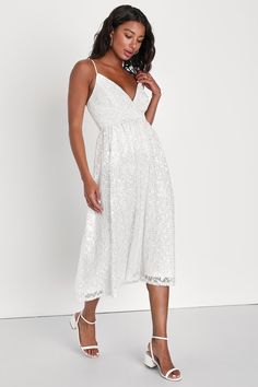 You'll be unforgettable when you arrive at the party in the Lulus Dreamy Drama White Lace Sequin A-Line Midi Dress! Gorgeous lace, with sparkling sequins throughout, overlays this perfect dress. Adjustable spaghetti straps support a surplice bodice with flattering seaming and a fitted waist. A-line skirt falls to a flattering midi hem. Hidden zipper/clasp at back for fit. Fit: This garment fits true to size. Length: Mid-calf length. Size medium measures 41" from adjustable straps to hem. Bust: G Glamorous Lace Bodice Dress For Prom Season, Glamorous Dresses With Lace Bodice For Prom Season, Glamorous Prom Dress With Lace Bodice, Glamorous Lace Summer Evening Dress, Glamorous Summer Lace Party Dress, Glamorous Summer Party Lace Dress, Chic V-neck Lace Party Dress, Lace Midi Length Evening Dress For Wedding Guest, Lace Midi Evening Dress For Wedding Guest