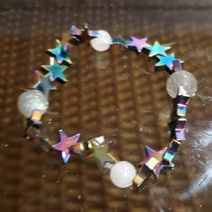 a close up of a bracelet with stars on it