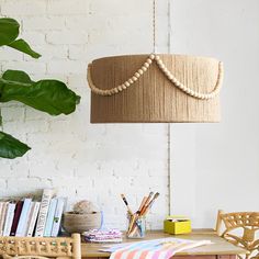 a room with a table, chair and lamp hanging from the ceiling