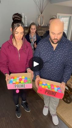 two people are holding boxes with candy in them and one man is looking at the box