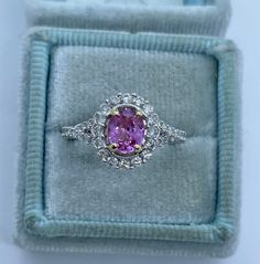 Beautiful pink sapphire diamond ring set in 18K White Gold. Excellent craftsmanship on this ring. The diamonds are all white and super sparkling. The split shank band is a pretty design detail. This pink sapphire is a beautiful light pink color. This ring is not flashy, but elegant and classy. Pink sapphires are hard durable stone and it sparkles a lot! The white gold feels nice and solid. The halo measures 11.1 x 10mm. Genuine pink sapphire oval cut 6.2 x 5 mm 0.9 Carats Beautiful pink color an Luxury Pink Ruby Ring In Platinum, Gia Certified Pink Diamond Ruby Ring, Pink Diamond Sapphire Ring, Gia Certified, Luxury Pink Sapphire Ring With Brilliant Cut, Luxury Gia Certified Pink Sapphire Diamond Ring, Formal Pink Diamond Ring In Platinum, Luxury Pink Sapphire Ring With Prong Setting, Pink Ruby Ring In Platinum, Pink Ruby Ring With Platinum