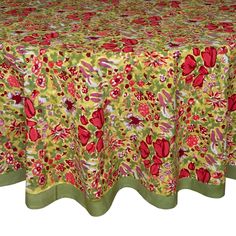 a table cloth with red and green flowers on it, in front of a white background