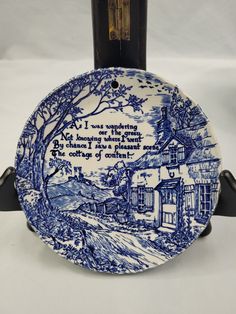 a blue and white plate with a poem on it