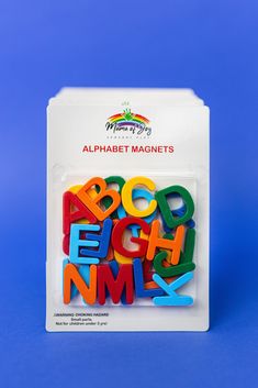 the alphabet magnets are in a plastic package on a blue background with white writing