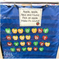 a bulletin board with apples and letters on it