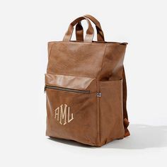 Keep up with all of your essentials with this spacious and cute Monogrammed Commuter Backpack Purse! This Personalized Backpack is a great way to keep all of your items in one place.This roomy bookbag lets you carry it all - and features a front pocket, two side pockets, two inner pockets, and a laptop pocket. For valuables or easy access, you'll love the front zippered pocket that features your choice of monogram. Use our exclusive monogram preview tool to see what your finished personalized la School Laptop Bag With Luggage Sleeve, School Laptop Bag Backpack With Luggage Sleeve, Everyday Laptop Bag For Back To School, Everyday Backpack With Zipper Pocket For Back To School, School Laptop Backpack With Luggage Sleeve, Everyday Softback Backpack With Cell Phone Pocket, Laptop Bag With Zipper Pocket For Everyday Use, Leather Tote Backpack With Zipper For School, Brown Backpack For Everyday And Back To School