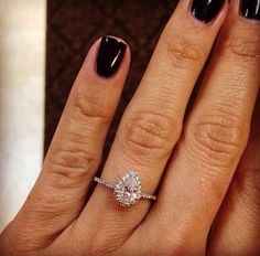 a woman's hand with a ring on top of it and an image of a diamond