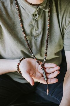 Limited to 10. Our new 9 Eye Dzi Wrist Mala combines petrified wood beads, powerful Rudrakshas, vintage brass spacers, and a Bodhi Seed guru bead. DharmaShop founder, Sander Cohen, sourced this 9 Eye Dzi bead on his last trip to Taiwan in 2019. Although it isn't ancient, this is one of the more exceptional beads made in the early 1990's. Because it is from the earth and was once organic material, Petrified Wood is known for its strong grounding properties and calming energies. This exclusive Dha Spiritual Wooden Beads Jewelry For Meditation, Spiritual Brown Beaded Bracelets For Rituals, Adjustable Artisan Mala For Rituals, Spiritual Brown Beaded Bracelets, Handmade Brown Beaded Bracelets For Ceremonial Use, Handmade Brown Beaded Bracelets For Rituals, Spiritual Wooden Beaded Healing Bracelets, Spiritual Hand-strung Beaded Bracelets For Rituals, Spiritual Healing Brown Beads