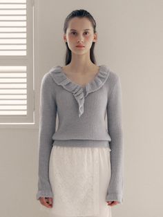 This frill collar knit top is perfect for adding a touch of loveliness to your outfit. It features frill detailing at the neckline and cuffs, exuding feminine mood.- Cropped length that makes your look stylish- Falls slimly on the body with an elastic waistband for a flattering fit- Versatile color for easy everyday wear without feeling burdensome Winter V-neck Top With Ruffles, Feminine Fine Knit Sweater, Feminine Fine Knit Winter Tops, Feminine Winter Tops For Workwear, Feminine Ruffled Tops For Winter, Elegant Ruffled Knit Top For Spring, Elegant Ruffle Knit Top For Spring, Elegant Spring Ruffle Knit Top, Chic Knit Top With Ruffles