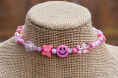 This fun choker is made of a mix of fun pink and white beads randomly strung on choker sized memory wire . **Please note: There is no clasp this choker simply wraps around the neck. See photo.** Pink Choker With Colorful Beads For Gift, Summer Pink Choker As Gift, Pink Adjustable Choker As A Gift, Fun Pink Beaded Necklaces With Letter Beads, Pink Beaded Choker For Festivals, Pink Round Beads Choker For Festival, Playful Pink Necklaces For Festivals, Pink Beaded Festival Choker Necklace, Pink Beaded Choker With Round Beads