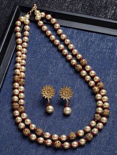 This jewelry set consists of a necklace and a pair of earrings Gold-plated necklace, has red and white pearl beaded detail and handcrafted work, secured by S-hook closure A pair of matching drop earrings, secured with a post-and-back closure Size & Fit Necklace : 56 cm x 2 cm (Length x Width) Earring : 3.5 cm x 1.9 cm (Length x Width) each Material & Care Material: Alloy Plated: Gold-Plated Dispatch within 7 days Festival Pearl Drop Necklaces With Round Beads, Festive Beaded Pearl Necklaces With Pearl Drop, Temple Jewelry Necklace With Pearl Drop And Round Beads, Festive Pearl Drop Necklace With Round Beads, Dangling Beads For Gifts And Festivals, Festival Pearl Drop Necklace With Round Beads, Red Round Beads Jewelry For Festivals, Gold Jewelry With Colorful Beads For Celebration, Pearl White Jewelry With Gold Round Beads