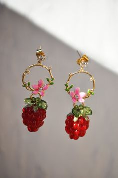 "Crown red raspberry fruit earrings, mulberry  glass drop earrings, food earrings, summer fruit earrings,  custom gift for her, mother's day These earrings are gorgeous and inspired by the Loire Valley in France. They are in the shape of a hand-painted flower crown, plated with 24k gold, which gives them an elegant and refined look. At the end of each earring, there is a carmine red Czech crystal raspberry, adding a touch of vivid color to the earrings. On either side of the raspberry, there is Red Dangle Jewelry With Fruit Design, Red Fruit Design Dangle Jewelry, Red Fruit Design Drop Earrings, Sweet Red Drop Earrings, Cute Red Earrings With Fruit Design, Summer Gift Cherry Earrings, Cute Berry Colored Jewelry With Fruit Design, Cute Berry-colored Jewelry With Fruit Design, Cute Berry-colored Fruit Design Jewelry