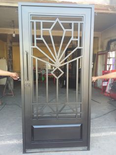 an iron door is opened to show the design on it's glass paneling