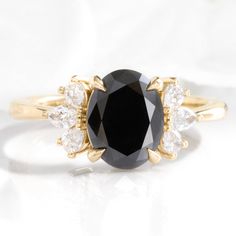 Oval black diamond engagement ring yellow gold 3 stone black diamond cluster ring la more design jewelry Black Sapphire Engagement Ring, Diamond Engagement Ring Gold, Diamond Alternative Engagement Ring, 3 Stone Diamond Ring, 3 Stone Ring, Three Stone Diamond Ring, Black Diamond Engagement, Gold Diamond Engagement Rings, 3 Stone Rings