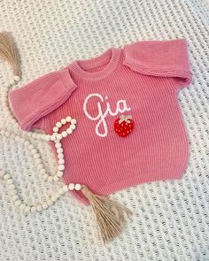 Looking for a unique and thoughtful gift for a new baby? A unique hand embroidered sweater for a special birthday kid?  This handmade sweater with embroidered strawberry design is a charming and one-of-a-kind item or gift that will be cherished for years to come. This oversized sweater is for babies, toddlers and children. You can add your name personalization in the box at check out.  This listing is for a baby name sweater with embroidered RED STRAWBERRY. Please see our other baby name sweater Cute Pink Sweater With Custom Embroidery, Name Sweater Baby, Baby Name Sweater, Hand Embroidered Sweater, Strawberry Sweater, Embroidered Strawberry, Name Sweater, Strawberry Design, Handmade Sweater