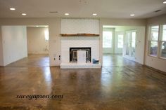 an empty living room with a fire place