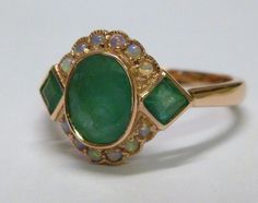 This STUNNING Vintage Inspired ring has been majestically crafted from 9ct Solid Rose Gold. A bezel set HUGE Oval cut NATURAL Emerald brings this ring to life along with two Vibrant Square cut NATURAL Emeralds resting on the shoulders adding additional appeal to this exquisitely feminine ring. Surrounding the face of this GORGEOUS ring are accentuating GENUINE Australian Opals which have been magnificently inset adding fire and exotic appeal to any lady who appreciates wearing such a fine ri... Emerald Opal Ring, Antique Cocktail Ring, Smaragd Ring, Emerald Ring Vintage, Vintage Inspired Rings, Ring Antique, Deco Jewelry, Square Cut, Opal Ring