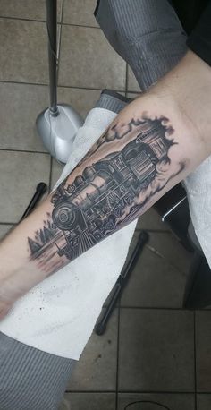 a man with a train tattoo on his arm