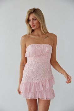 Make an entrance in the Cece Strapless Lace Ruffle Tie Back Mini Dress! This gorgeous dress features a strapless neckline, lace up back, and a floral lace overlay with polkadot ruffle details. Available in dusty pink and white! Pair with a simple heel to complete the look! Details 100% Polyester Ruffle hem Boning for structure Silicon grip Hidden back zipper with clasp Hand wash cold / Line dry Pink Hoco Dress, Spring Fling Dress, Cute Formal Dresses, Cute Homecoming Dresses, American Threads, Rush Dresses, Rosie Huntington, Prom Dress Inspiration, Lace Strapless