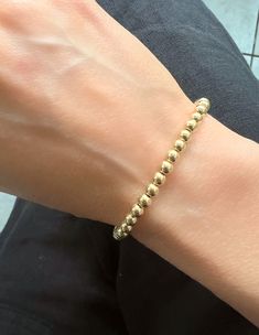 This Italian 14K Yellow Gold Ball Chain Bracelet is ideal for everyday wear. Measuring 7" in length, it features 3mm and 4mm links secured with a lobster clasp. Thank you for visiting our shop!Visit our website DmKJewelry.comAlso Follow us on Instagram https://www.instagram.com/dmkjewelryny/ Everyday Flexible Round Gold Bracelet, Classic Single Strand Beaded Bracelets For Everyday, Classic Single Strand 14k Gold Bracelet, Classic 14k Gold Single Strand Bracelet, Classic Everyday Round Beaded Bracelets, Classic 14k Gold Beaded Bracelets For Everyday, Classic Everyday 14k Gold Beaded Bracelets, Everyday Classic 14k Gold Beaded Bracelets, Classic Hand-strung Gold Bracelet Gift