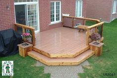 a wooden deck in front of a brick building