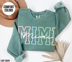 You will love this Comfort Colors sweatshirt for your Mimi.  This crewneck sweatshirt has a colorful design on the front of the sweatshirt that says Mimi.  This minimalist sweater will be perfect for your Mimi's Birthday, Mimi's Christmas or Mimi's Mother's Day.  Your Mimi will love wearing this trendy sweater this fall and winter season. Link to short sleeve t-shirt: https://etsy.me/3TPf3OW Link to Sweatshirt: https://etsy.me/3XGyUAN Link to Long Sleeve Shirt: https://etsy.me/3zCxb7A Attn: I am Cute Green Sweatshirt With Letter Print, Mimi Birthday, Minimalist Sweater, Mimi Gift, Trendy Sweater, Comfort Colors Sweatshirt, Trendy Sweaters, Colorful Design, Winter Season