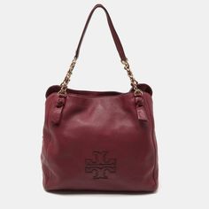 TORY BURCH Burgundy Leather Chain ToteThe fashion house's tradition of excellence, coupled with modern design sensibilities, works to make this bag one of a kind. Its a fabulous accessory for everyday use. Size: Height: 30 cm, Width: 17 cm, Length: 32 cmMaterial: Leather Burgundy Bag, Balenciaga Designer, Tory Burch Bag, Fashion House, Leather Chain, Brand Colors, Womens Tote Bags, The Fashion, Luxury Bags