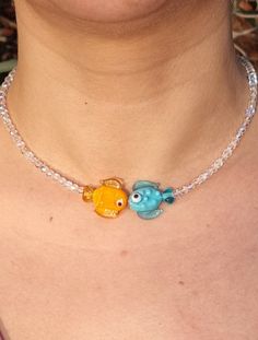 Fish Necklace with Murano Glass is a Handmade Candy Choker adorned with Rainbow Color Changing Crystals, featuring Pink, Blue, Green, and Orange Fish Variants. You will receive 1 necklace. 👀Discover Similar Murano Jewelries https://www.etsy.com/shop/demetergemart/?etsrc=sdt§ion_id=44661532 🙌SATISFACTION ♥ Your satisfaction is our top priority. ♥ We want you to absolutely love your purchase, which is why we've made our return process incredibly simple. ♥ If, for any reason, you receive your ite Murano Necklace, Kalung Manik-manik, Murano Jewelry, Crystals Pink, Simple Beaded Necklaces, Handmade Candy, Orange Fish, Fish Jewelry, Murano Glass Jewelry