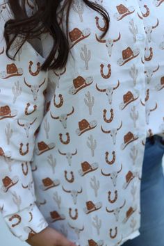 Loving this Smashed Western print long sleeve white shirt. The cowboy hat, horseshoe, steerhead and cactus in the clay color make this a fun shirt to pair alone or under a sweater, vest or blazer! Western Shirts For Women, Long Sleeve White Shirt, Clay Color, Fun Shirt, White Long Sleeve Shirt, Handcrafted Accessories, The Cowboy, Graphic Tops, Romper Dress