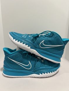 a pair of blue and white nike basketball shoes on a white surface, with the bottom part of the shoe visible